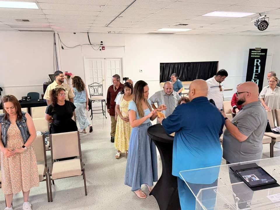 Group of people networking and socializing in a community center or event space